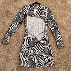 This is a black and white, asymmetrical short dress